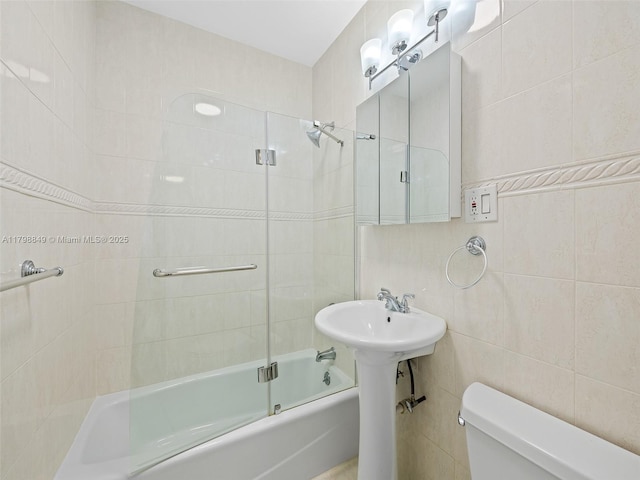 1730 NE 16th St, Fort Lauderdale, FL 33304 - full bathroom featuring tile walls, toilet, and combined bath / shower with glass door