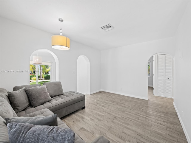1730 NE 16th St, Fort Lauderdale, FL 33304 - living area featuring arched walkways, light wood-style floors, and baseboards
