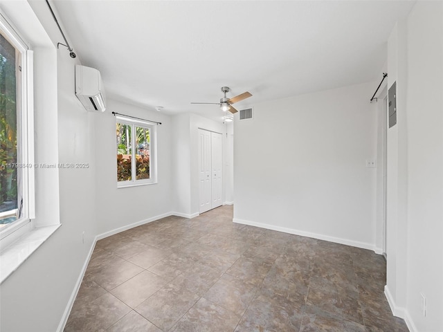 1730 NE 16th St, Fort Lauderdale, FL 33304 - spare room with a wall unit AC, a ceiling fan, and baseboards