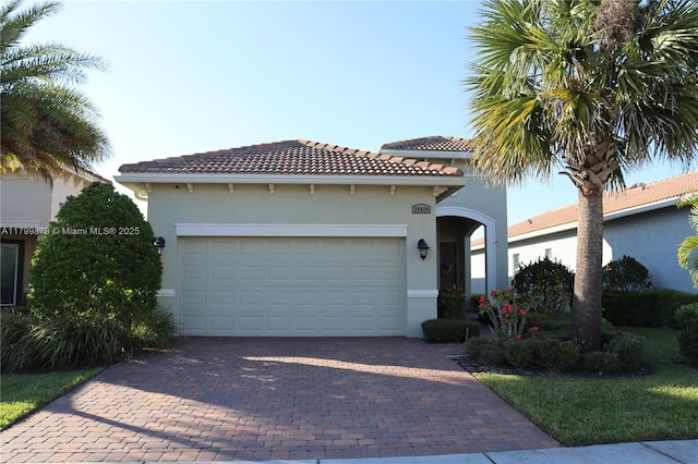 20028 SW Caserta Way, Port St Lucie, FL 34986 - mediterranean / spanish-style home with stucco siding, decorative driveway, a tile roof, and an attached garage