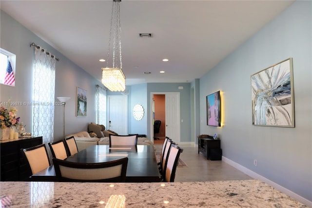 20028 SW Caserta Way, Port St Lucie, FL 34986 - dining space featuring healthy amount of natural light, baseboards, recessed lighting, finished concrete flooring, and a chandelier
