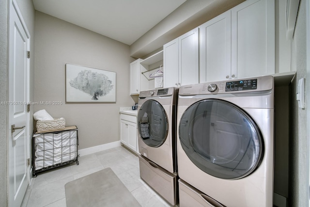 15978 SW 276th St, Homestead, FL 33031 - laundry area with cabinet space, separate washer and dryer, baseboards, and light tile patterned floors