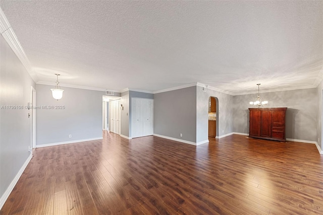 6668 Burning Wood Dr Unit 166, Boca Raton, FL 33433 - unfurnished living room featuring arched walkways, dark wood-style floors, a textured ceiling, a chandelier, and baseboards