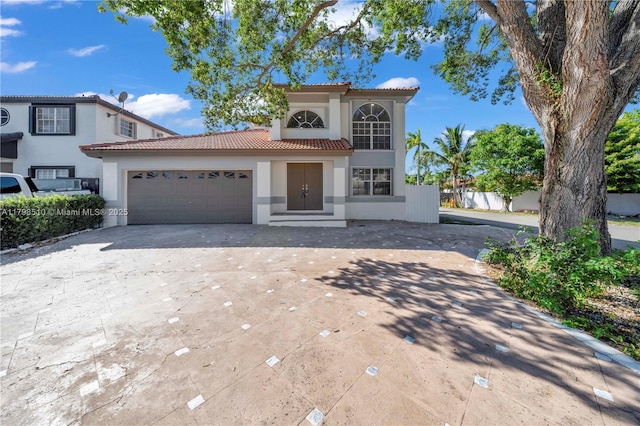 20076 NW 85th Ave, Hialeah, FL 33015 - mediterranean / spanish house with a tiled roof, concrete driveway, an attached garage, and stucco siding