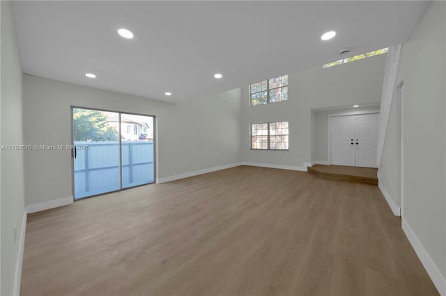 20076 NW 85th Ave, Hialeah, FL 33015 - unfurnished living room featuring baseboards, light wood-style floors, and recessed lighting