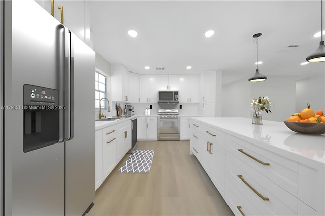 20076 NW 85th Ave, Hialeah, FL 33015 - kitchen featuring appliances with stainless steel finishes, a sink, light wood finished floors, light countertops, and recessed lighting
