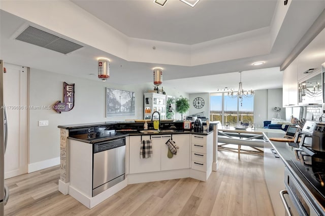14951 Royal Oaks Ln Unit 1409, North Miami, FL 33181 - kitchen with appliances with stainless steel finishes, open floor plan, light wood-style flooring, dark countertops, and white cabinetry