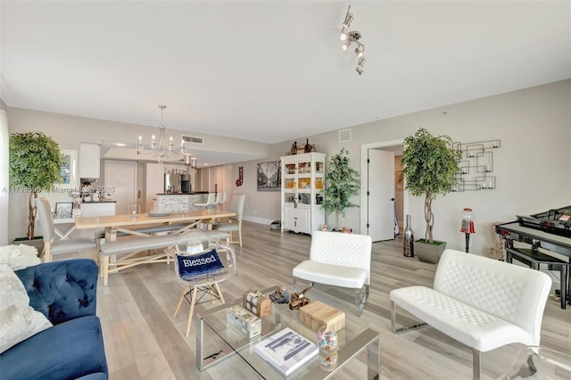 14951 Royal Oaks Ln Unit 1409, North Miami, FL 33181 - living area with a chandelier and light wood finished floors