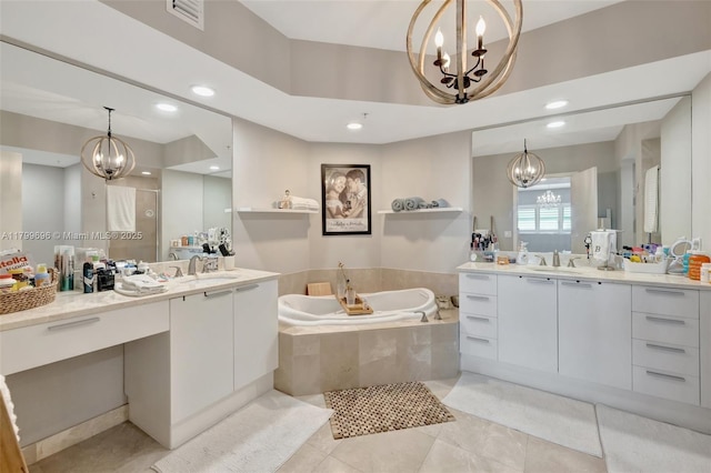 bathroom with a chandelier, a garden tub, two vanities, tile patterned floors, and recessed lighting