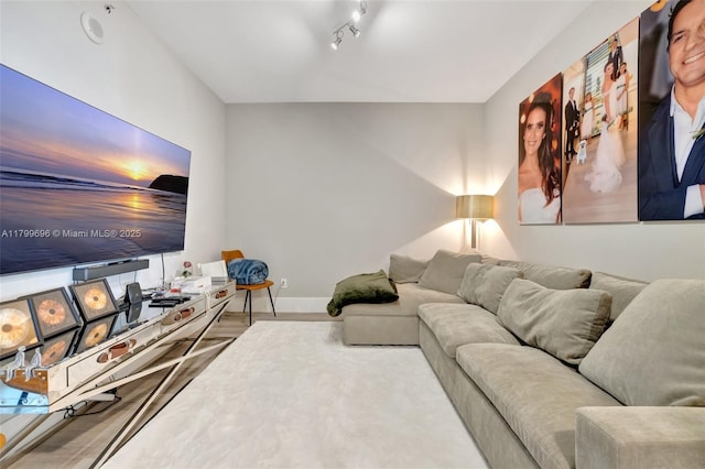 living room featuring baseboards and wood finished floors