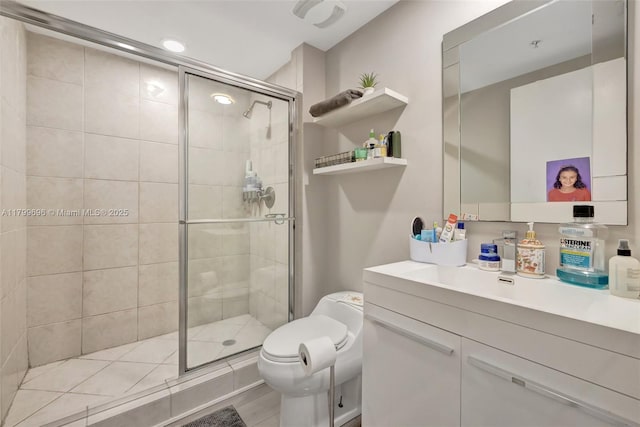 full bath featuring a stall shower, vanity, toilet, and recessed lighting