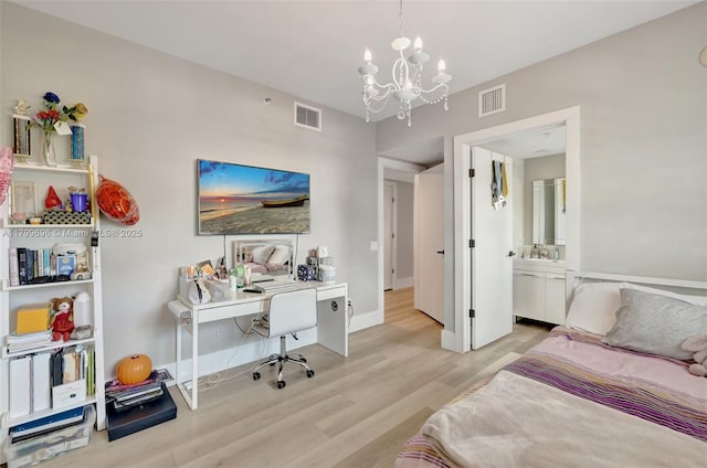 bedroom featuring a chandelier, light wood-style floors, baseboards, and a desk