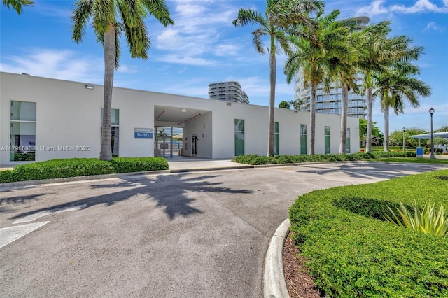 view of property featuring driveway and a carport
