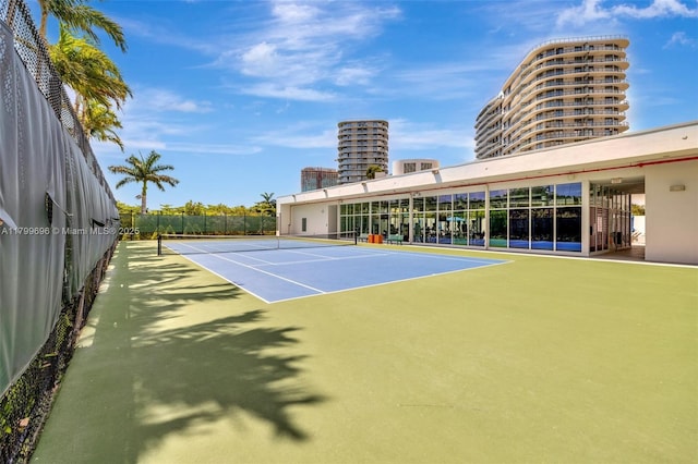 view of tennis court featuring fence