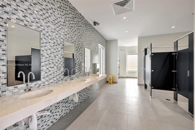 bathroom with backsplash, tile patterned flooring, recessed lighting, and double vanity