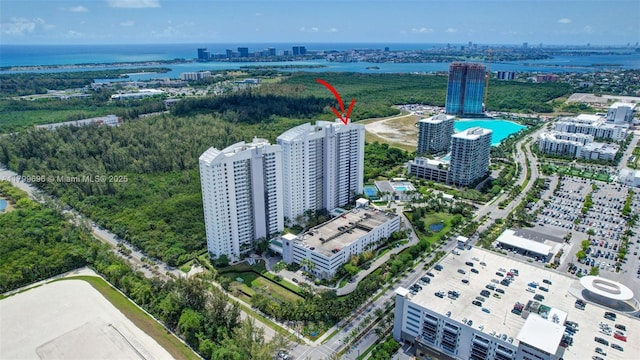view of urban area with a nearby body of water and a pool