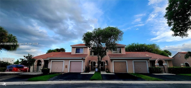 16624 Greens Edge Cir Unit 75, Weston, FL 33326 - mediterranean / spanish-style home featuring a tile roof, stucco siding, and driveway