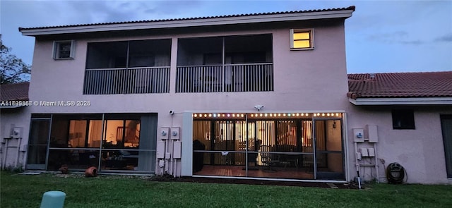16624 Greens Edge Cir Unit 75, Weston, FL 33326 - back of property with stucco siding, a yard, and a tiled roof