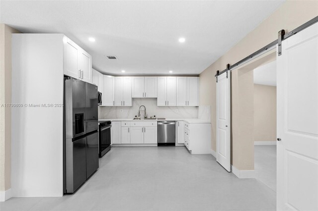 9300 Marine Dr, Cutler Bay, FL 33189 - kitchen with black fridge with ice dispenser, dishwasher, stove, a barn door, and recessed lighting