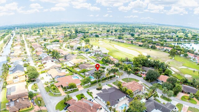 7345 N Oakmont Dr, Hialeah, FL 33015 - aerial view of property and surrounding area featuring nearby suburban area, a golf club, and a nearby body of water