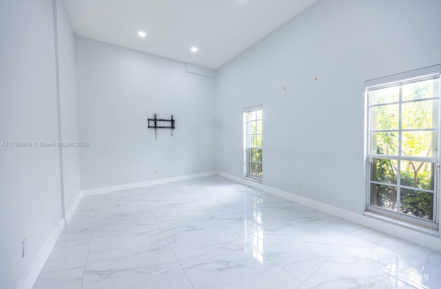 7345 N Oakmont Dr, Hialeah, FL 33015 - empty room featuring light marble finish flooring, baseboards, recessed lighting, and a high ceiling