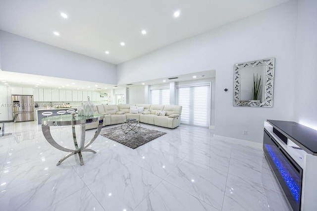7345 N Oakmont Dr, Hialeah, FL 33015 - living room featuring light marble finish floors, a high ceiling, recessed lighting, and baseboards