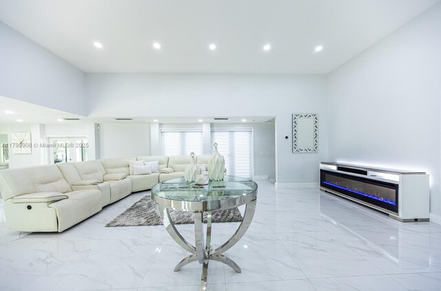 7345 N Oakmont Dr, Hialeah, FL 33015 - living area featuring light marble finish floors, baseboards, recessed lighting, and plenty of natural light