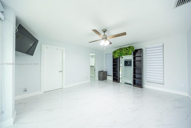 7345 N Oakmont Dr, Hialeah, FL 33015 - unfurnished living room with marble tiled floors, baseboards, and a ceiling fan
