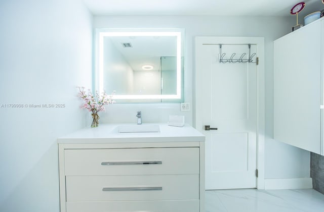 7345 N Oakmont Dr, Hialeah, FL 33015 - bathroom featuring vanity, marble finish flooring, and baseboards