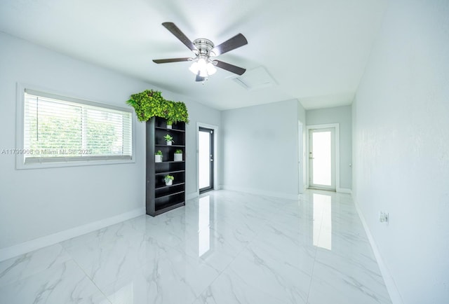 7345 N Oakmont Dr, Hialeah, FL 33015 - unfurnished room with baseboards, attic access, light marble finish flooring, and a ceiling fan