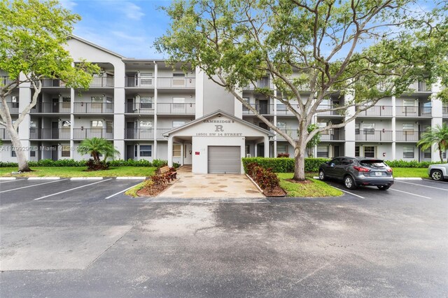 12501 SW 14th St Unit 108R, Pembroke Pines, FL 33027 - view of apartment building / complex featuring uncovered parking