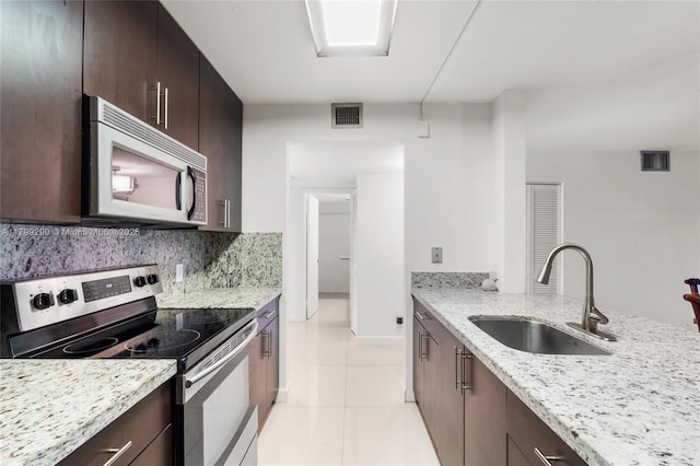 12501 SW 14th St Unit 108R, Pembroke Pines, FL 33027 - kitchen featuring appliances with stainless steel finishes, a sink, dark brown cabinets, and light tile patterned floors