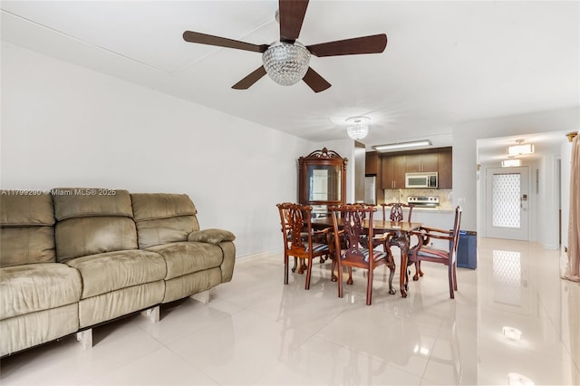 12501 SW 14th St Unit 108R, Pembroke Pines, FL 33027 - dining space with ceiling fan, light tile patterned floors, and baseboards