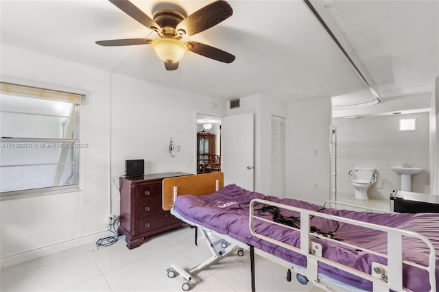 12501 SW 14th St Unit 108R, Pembroke Pines, FL 33027 - bedroom featuring light tile patterned floors, ensuite bathroom, a sink, and a ceiling fan