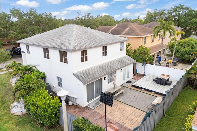 1463 NW 48th Ave, Coconut Creek, FL 33063 - back of property featuring roof with shingles, stucco siding, a fenced backyard, and a patio area