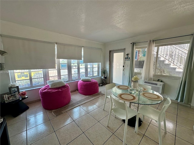 7435 Harding Ave Unit 101, Miami Beach, FL 33141 - dining space featuring a textured ceiling, crown molding, light tile patterned flooring, and an AC wall unit