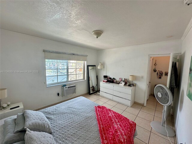 7435 Harding Ave Unit 101, Miami Beach, FL 33141 - bedroom featuring light tile patterned flooring, an AC wall unit, a textured ceiling, and ornamental molding