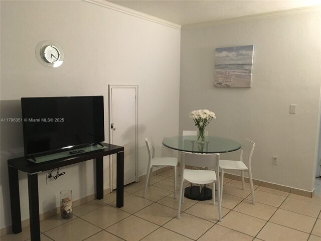 7435 Harding Ave Unit 101, Miami Beach, FL 33141 - dining area with ornamental molding, baseboards, and light tile patterned flooring