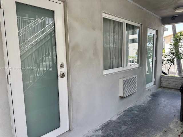 7435 Harding Ave Unit 101, Miami Beach, FL 33141 - entrance to property with stucco siding and a wall mounted AC