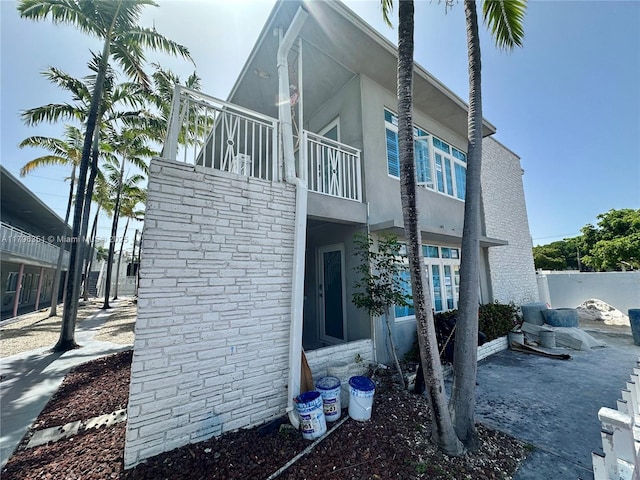 7435 Harding Ave Unit 101, Miami Beach, FL 33141 - view of side of property with a balcony and stucco siding