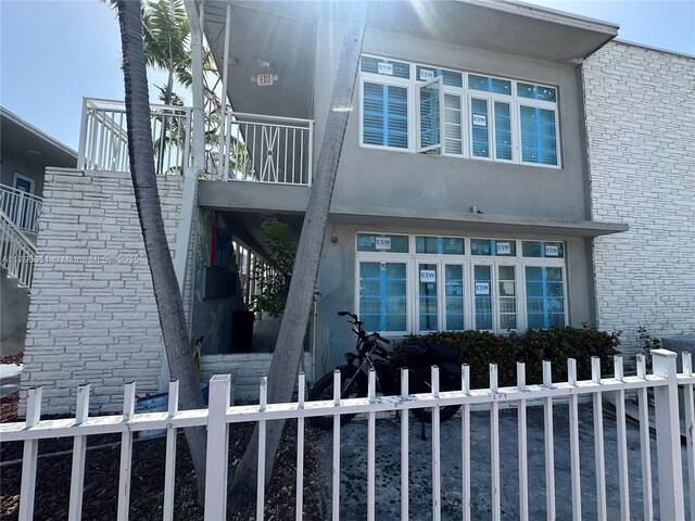 7435 Harding Ave Unit 101, Miami Beach, FL 33141 - view of side of property with stucco siding and stairway