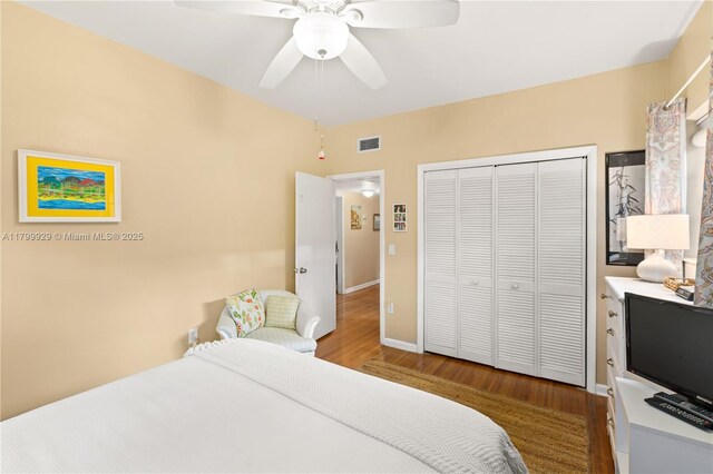 425 Cadagua Ave, Coral Gables, FL 33146 - bedroom with wood finished floors, a closet, a ceiling fan, and baseboards