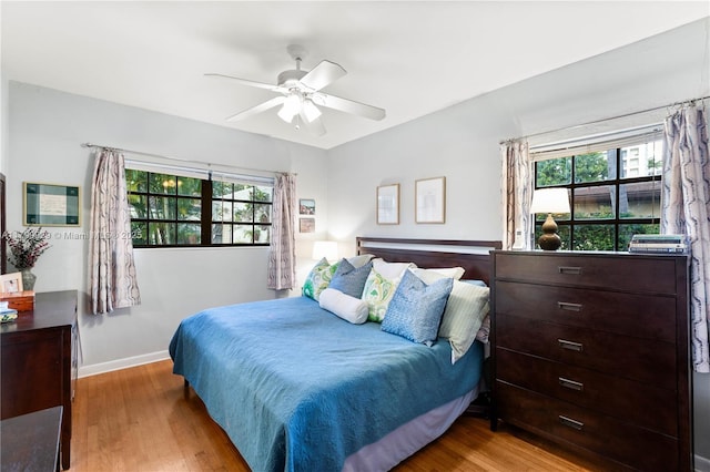 425 Cadagua Ave, Coral Gables, FL 33146 - bedroom featuring wood finished floors, baseboards, multiple windows, and ceiling fan