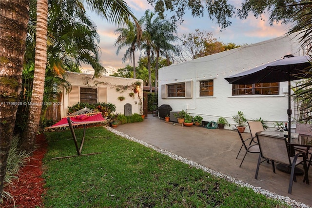 425 Cadagua Ave, Coral Gables, FL 33146 - patio terrace at dusk with a yard