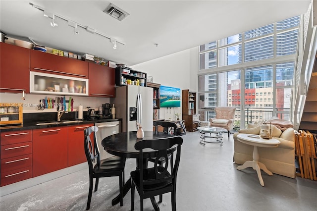 244 Biscayne Blvd Unit 645, Miami, FL 33132 - dining area with finished concrete flooring, rail lighting, and a towering ceiling