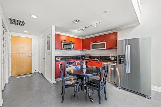 244 Biscayne Blvd Unit 645, Miami, FL 33132 - kitchen featuring appliances with stainless steel finishes, dark countertops, concrete flooring, and recessed lighting