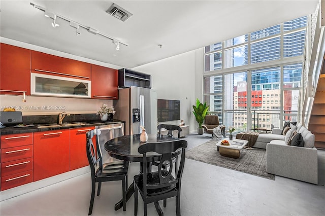 244 Biscayne Blvd Unit 645, Miami, FL 33132 - dining area with rail lighting and finished concrete floors
