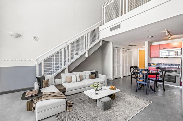 244 Biscayne Blvd Unit 645, Miami, FL 33132 - living room featuring concrete floors and stairway