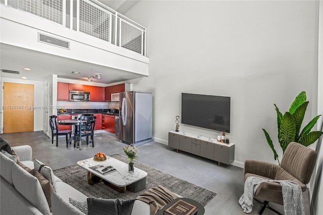 244 Biscayne Blvd Unit 645, Miami, FL 33132 - living area featuring concrete floors and a high ceiling