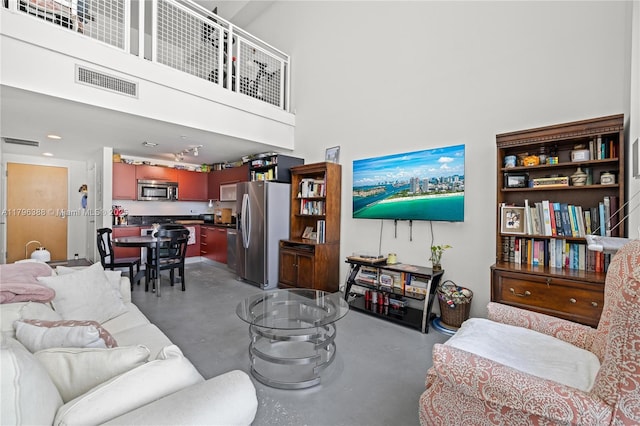 244 Biscayne Blvd Unit 645, Miami, FL 33132 - living area featuring concrete floors, a towering ceiling, and recessed lighting
